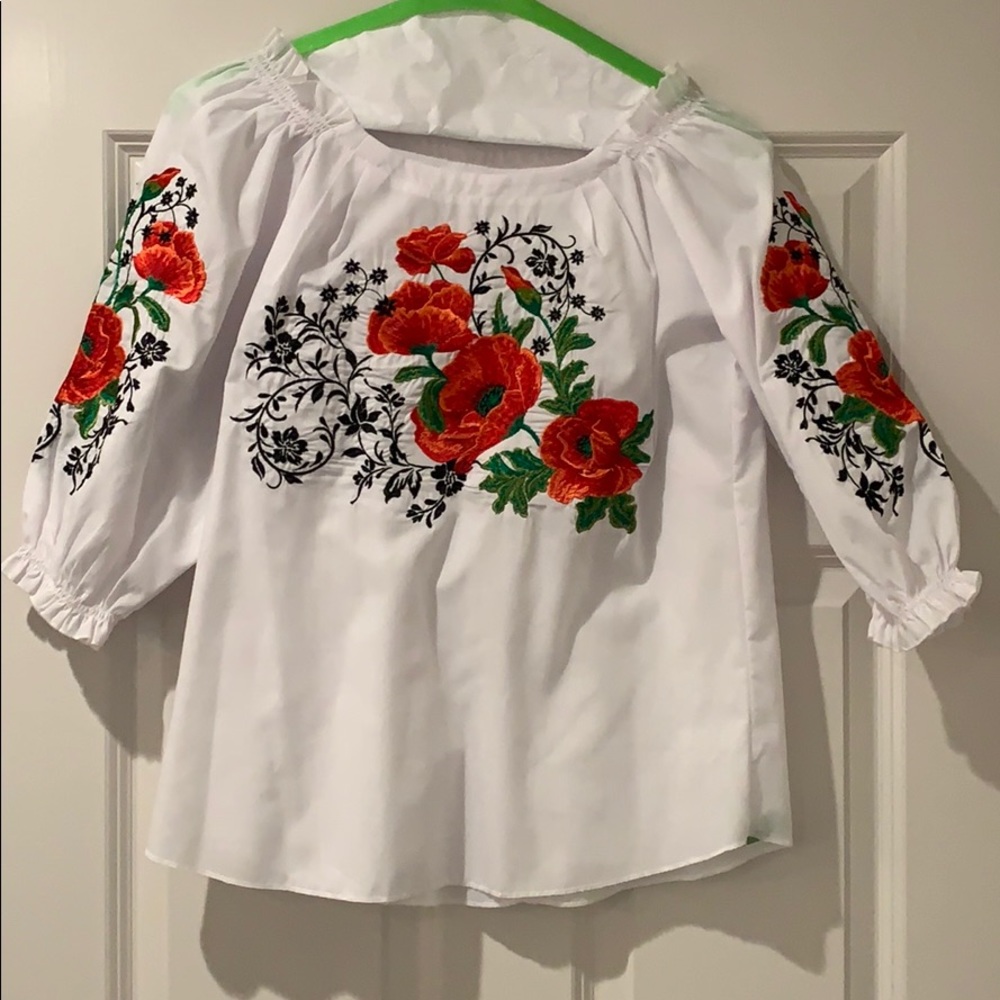 White, embroidered Mexican shirt with read roses.